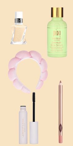 various beauty products and makeup items on a beige background, including lipstick, eyeliners, mascara, lip glosses