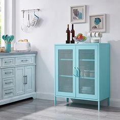 a blue cabinet in a white room next to a window