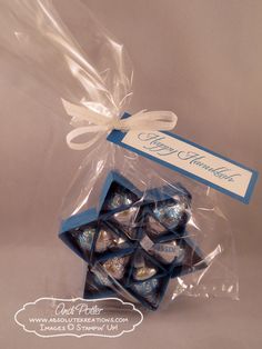 a package of blue and white chocolates wrapped in clear cellophane with a ribbon