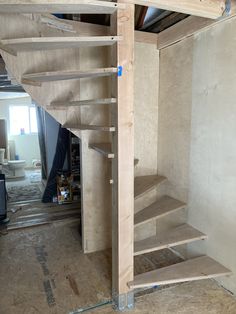 an unfinished staircase being built into the wall in a room with no flooring or walls