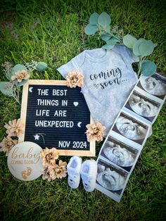 the baby announcement is laid out on the grass