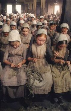 a large group of women in dresses and bonnets