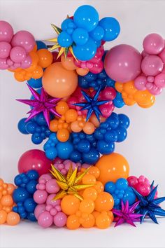 balloons and starbursts are arranged in the shape of an eiffel tower