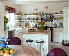 a kitchen filled with lots of counter space next to a wooden dining room table and chairs