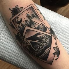 a black and white tattoo on the arm of a man with an abstract geometric design