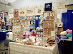 there are many items on display at this market stall that is selling souvenirs