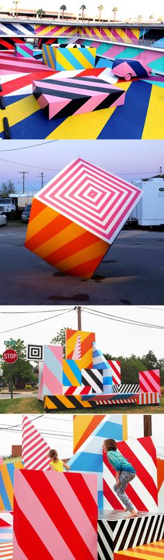 there are many colorful sculptures in the street and one is upside down on it's side