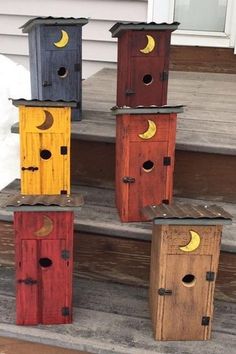 several birdhouses with moon and crescent designs on them