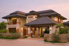 a large house with lots of windows on the front and side of it's roof