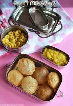 three metal containers filled with macaroni and cheese next to two bowls of food