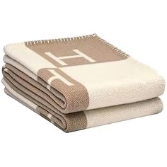 three towels stacked on top of each other in front of a white background with the letter f