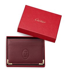 Cartier proves that its expert craftsmanship goes beyond jewellery and into the world of leather goods. Like all the accessories hailing from the Must de Cartier collection, this double card holder is immaculately presented with the Double C logo and is endlessly sleek. The best part? Its compact, slim design can store up to five credit cards and a handful of notes – travelling light has never been easier. Cartier Card Holder, Mens Cartier, Cartier Collection, Holiday Boutique, Passport Holders, Cartier Jewelry, C Logo, Card Holder Wallet, Slim Design