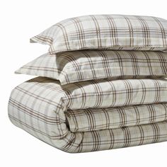 three pillows stacked on top of each other in front of a white background with brown and tan plaid