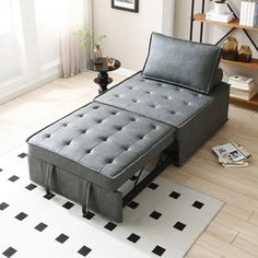 a bed that is sitting in the middle of a room with black and white rugs