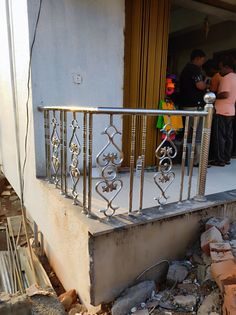 people are standing on the balcony of an apartment building that has been gutted and destroyed