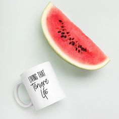 a slice of watermelon next to a coffee mug with the words if it's movement