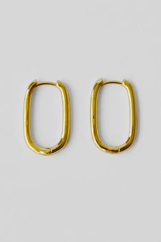 A pair of classic oblong hoop earrings in 18k shiny gold filled brass. Details: Classic oblong link hoop earrings Sold by the pair 20x12x2mm Shiny 18k gold filled brass Made in China Gold Oval Hoop Earrings Minimalist Style, Gold Oval Minimalist Hoop Earrings, Minimalist Gold Oval Hoop Earrings, Gold Minimalist Oval Hoop Earrings, Minimalist Tarnish-resistant Oblong Jewelry, Gold Plated Oval Huggie Earrings, Minimalist Gold Plated Oval Hoop Earrings, Everyday Gold Oblong Jewelry, Everyday Yellow Gold Oval Link Earrings