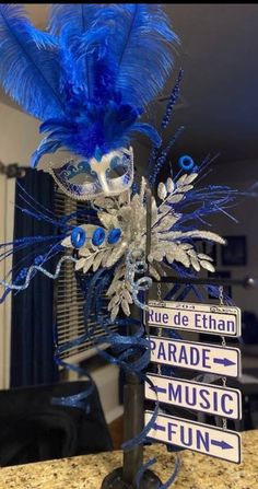 a street sign with blue feathers on it