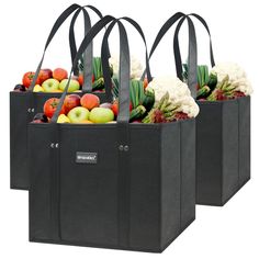 three black shopping bags filled with fruit and vegetables