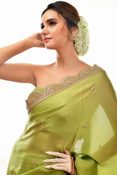 This elegant saree features a light green satin fabric and a stunningly hand-embroidered scalloped border. The gota patti design provides texture and dimension, making this saree a perfect choice for special occasions. Green Art Silk Pre-draped Saree With Embroidered Border, Green Dola Silk Pre-draped Saree With Dupatta, Designer Green Pre-draped Saree With Embroidered Border, Green Dola Silk Pre-draped Saree For Diwali, Elegant Pista Green Dola Silk Pre-draped Saree, Pista Green Sharara With Embroidered Border, Elegant Green Lehenga With Embroidered Border, Pista Green Chanderi Sharara With Embroidered Border, Elegant Pista Green Pre-draped Saree For Festivals