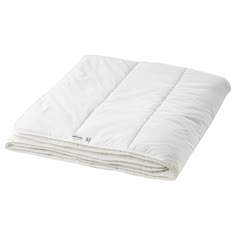 the white blanket is folded up on top of each other and ready to be used as a comforter