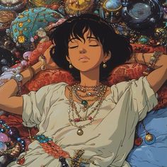 a woman laying on top of a bed covered in lots of beads and necklaces