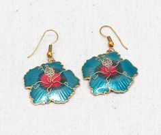 "Lovely Blue and Pink Tropical Hibiscus Flower Cloisonne Enameled Metal Earrings. Measure 1 1/8\" inches Tall x 1 1/8\" inches Wide. Drop measures 1 7/8\" inches from the top of the hook. Great shape. No damage." Blue Enamel Flower Earrings As Gift, Nickel-free Enamel Flower Jewelry, Flower Shaped Enamel Jewelry For Pierced Ears, Nickel-free Enamel Flower Earrings, Nickel-free Flower-shaped Enamel Jewelry, Traditional Blue Flower Jewelry, Cloisonne Enamel, Hibiscus Flowers, Metal Earrings