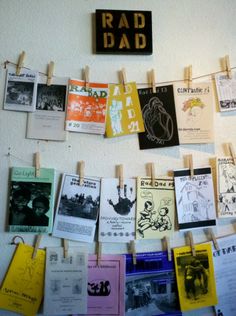 a bulletin board that has some pictures on it with clothes pins attached to it and the words rad dad