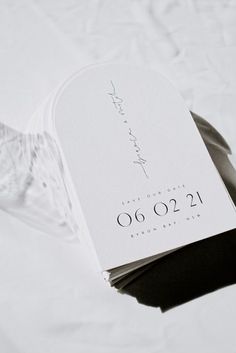 a white wedding card with the date on it