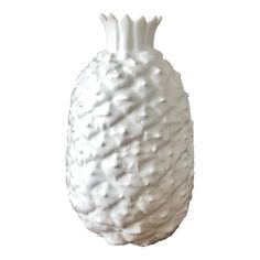 a white ceramic vase sitting on top of a table