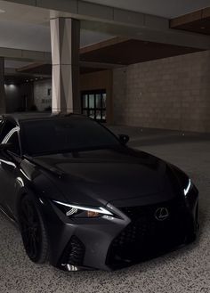 a black car is parked in an empty parking garage