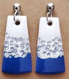 These handmade polymer clay dangle earrings feature a dazzling blue, white and silver color combination. Their intricate design is perfect for adding a touch of chic sophistication to any look. Each earring is lightweight and comfortable, allowing for all-day wear.  Hypoallergenic. Silver Dangle Earrings In Polymer Clay, White Dangle Earrings In Polymer Clay, Nickel Free Silver Polymer Clay Earrings, White Polymer Clay Dangle Earrings, Handmade White Resin Earrings, Clay Dangle Earrings, Sun City, Intricate Design, Handmade Polymer Clay