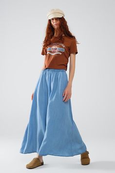 Introducing our blue Tencel denim-styled maxi skirt, designed for effortless elegance and versatility. Made from 100% Tencel, this skirt offers a soft, flowing feel that's perfect for a range of occasions.  The relaxed fit and high rise ensure a comfortable and flattering silhouette, while the maxi length adds a touch of sophistication. Whether you pair it with sandals for a chic holiday look or sneakers for a more casual everyday style, this skirt adapts seamlessly to your needs. Our model, wit Tencel Denim, Maxi Skirt Style, Chic Holiday, Skirt Jumpsuit, Blue Maxi, Flowing Skirt, Romper Pants, Casual Everyday, Sweater Coats