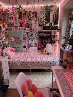 a bedroom decorated in pink and white with hello kitty decorations