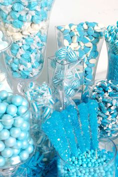 blue and white candies in clear vases with candy on the bottom one side