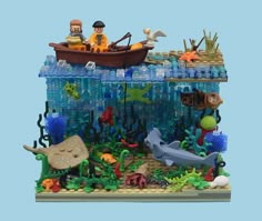 a lego model of a man and woman in a boat surrounded by sea life, under water