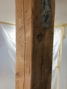 a piece of wood that has been nailed to the side of a pole with a hole in it