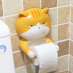 a yellow and white cat figurine holding a roll of toilet paper