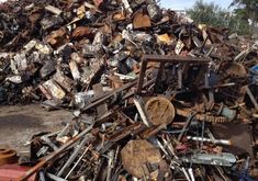 a pile of scrap metal sitting on top of a street