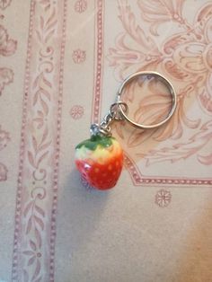 a keychain that has an apple on it