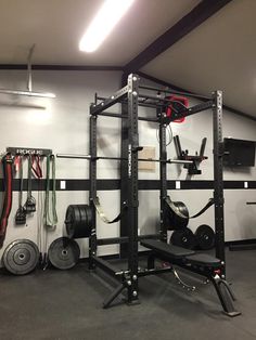 an empty garage with various equipment in the area and on the wall is a gym