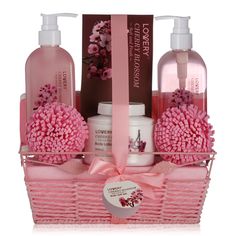 a pink basket with soaps, lotion and other items in it on a white background