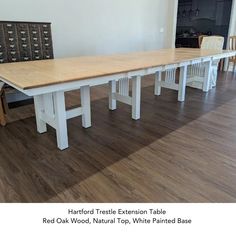 a long table with two chairs next to it on a hard wood floored room