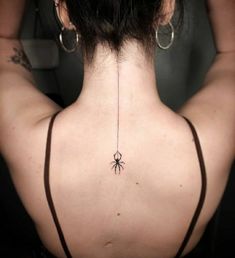 a woman with a spider tattoo on her back