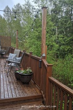 a wooden deck with chairs and table on it