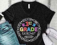 Introducing our inspiring and vibrant 1st Grade Teacher V-Neck T-Shirt, a perfect blend of comfort and motivation that's tailored exclusively for educators who light up young minds! The design comes to life with a burst of vivid colors, creating an engaging visual that's sure to captivate your young learners. The flattering V-neck cut and relaxed fit provide an easygoing style that pairs seamlessly with any outfit, whether you're teaching a math lesson or an art project. Looking for the perfect First Grade Teacher Shirts, 1st Grade Teacher Shirts, 1st Grade Teacher, First Grade Teacher, 2nd Grade Teacher, First Grade Teachers, Teacher Tshirts, School Shirts, Math Lessons