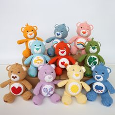 a group of crocheted teddy bears sitting next to each other