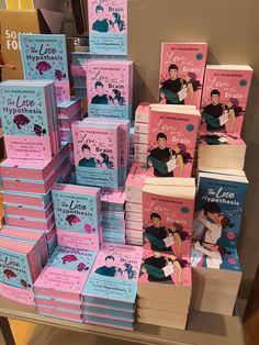 many books are stacked on top of each other in front of a store display case