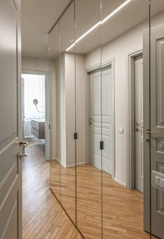 an empty room with mirrored doors and wooden floors