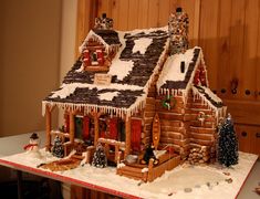 a gingerbread house with icing on the roof